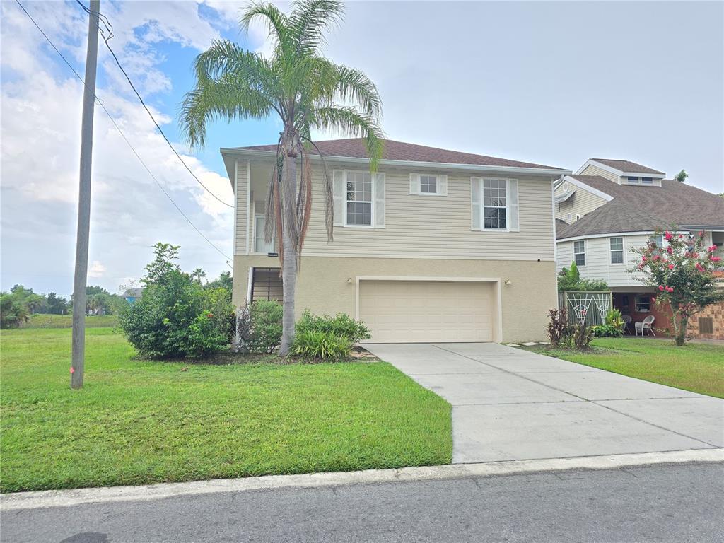 3263 Sea Grape Drive Hernando Beach, FL 34607 - Photo 1 of 1 a front view of house with yard and green space