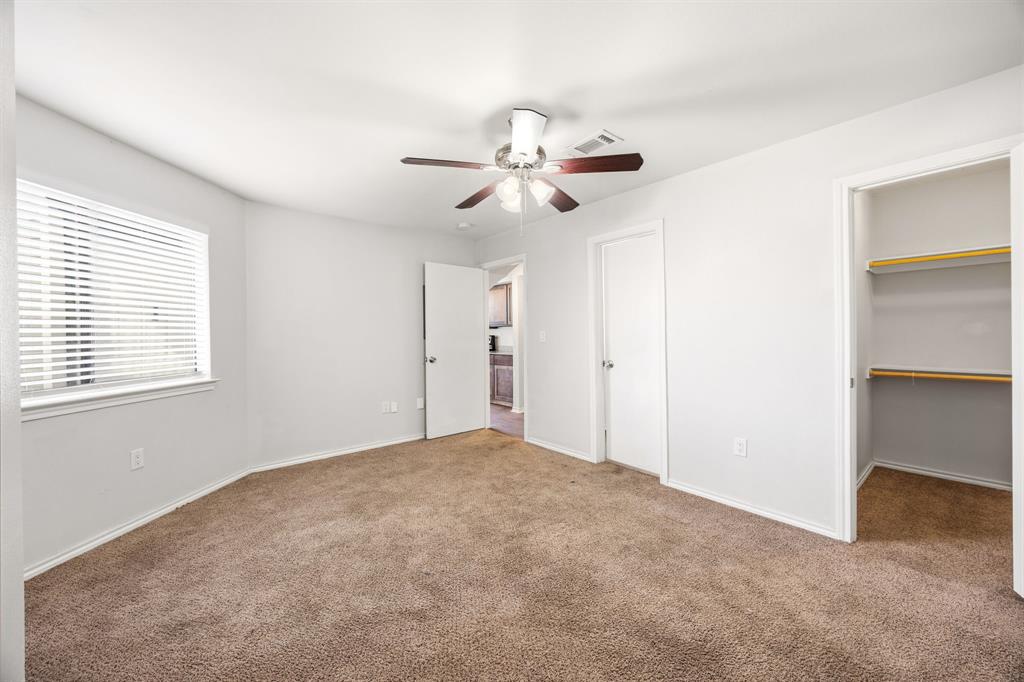 9837 Walnut Street, Unit S203 Dallas, TX 75243 - Photo 15 of 26 Bedroom featuring carpeted flooring, a window with blinds, a ceiling fan, and a built-in closet with shelving