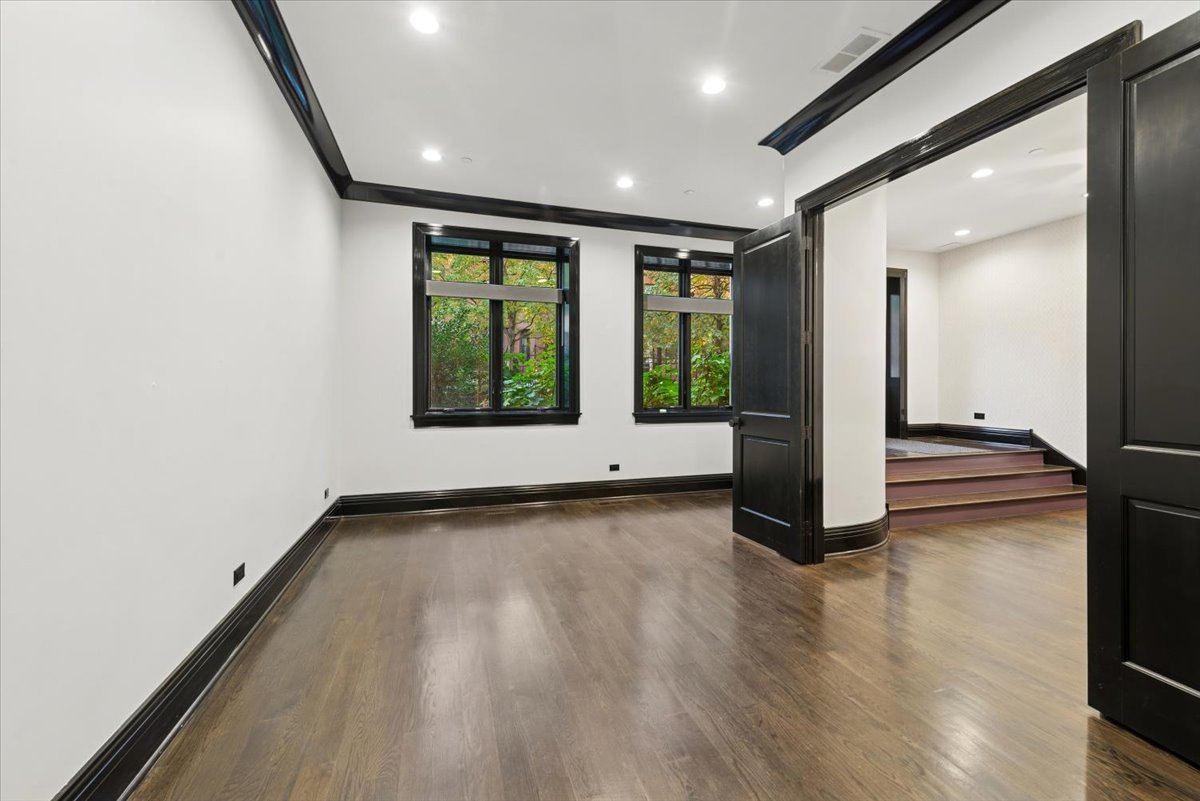 457 West Deming Place Chicago, IL 60614 - Photo 21 of 63 an empty room with wooden floor and windows