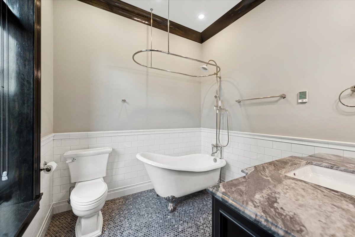 457 West Deming Place Chicago, IL 60614 - Photo 23 of 63 a bathroom with a granite countertop sink and a toilet