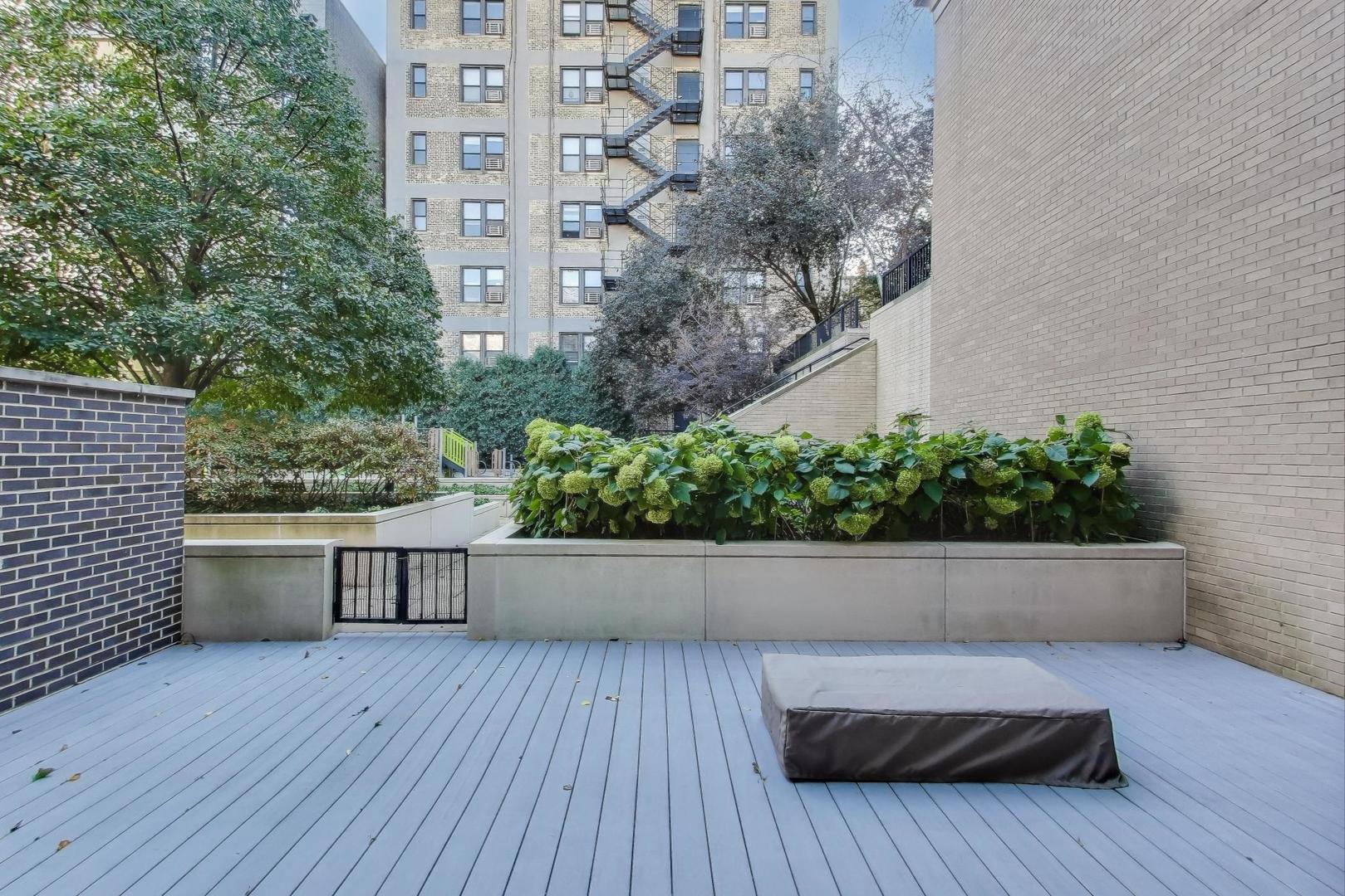 457 West Deming Place Chicago, IL 60614 - Photo 33 of 63 a view of balcony with wooden floor and plants