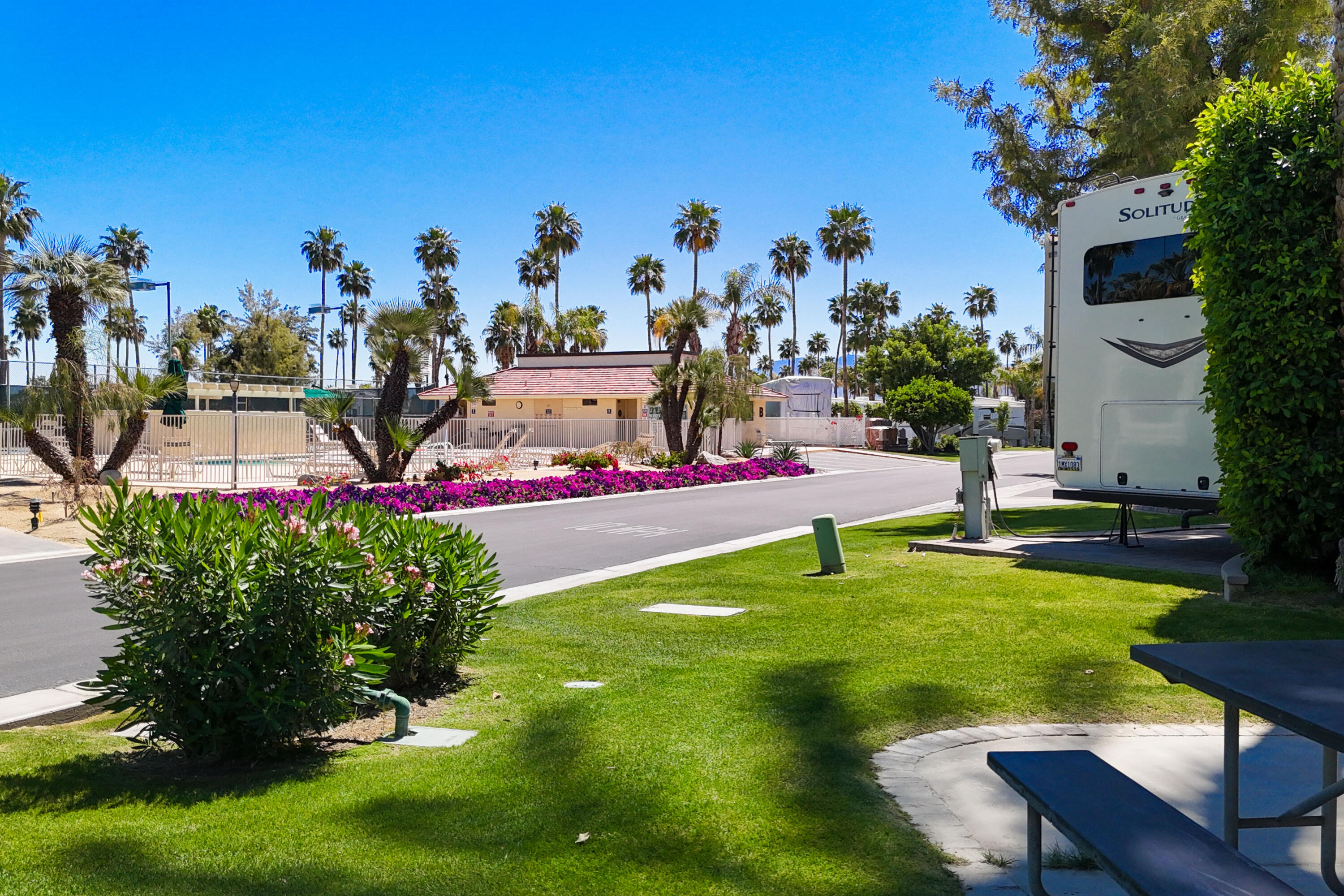 69411 Ramon Road, Unit 504 Cathedral City, CA 92234 - Photo 13 of 56 a view of a swimming pool with a table and chairs