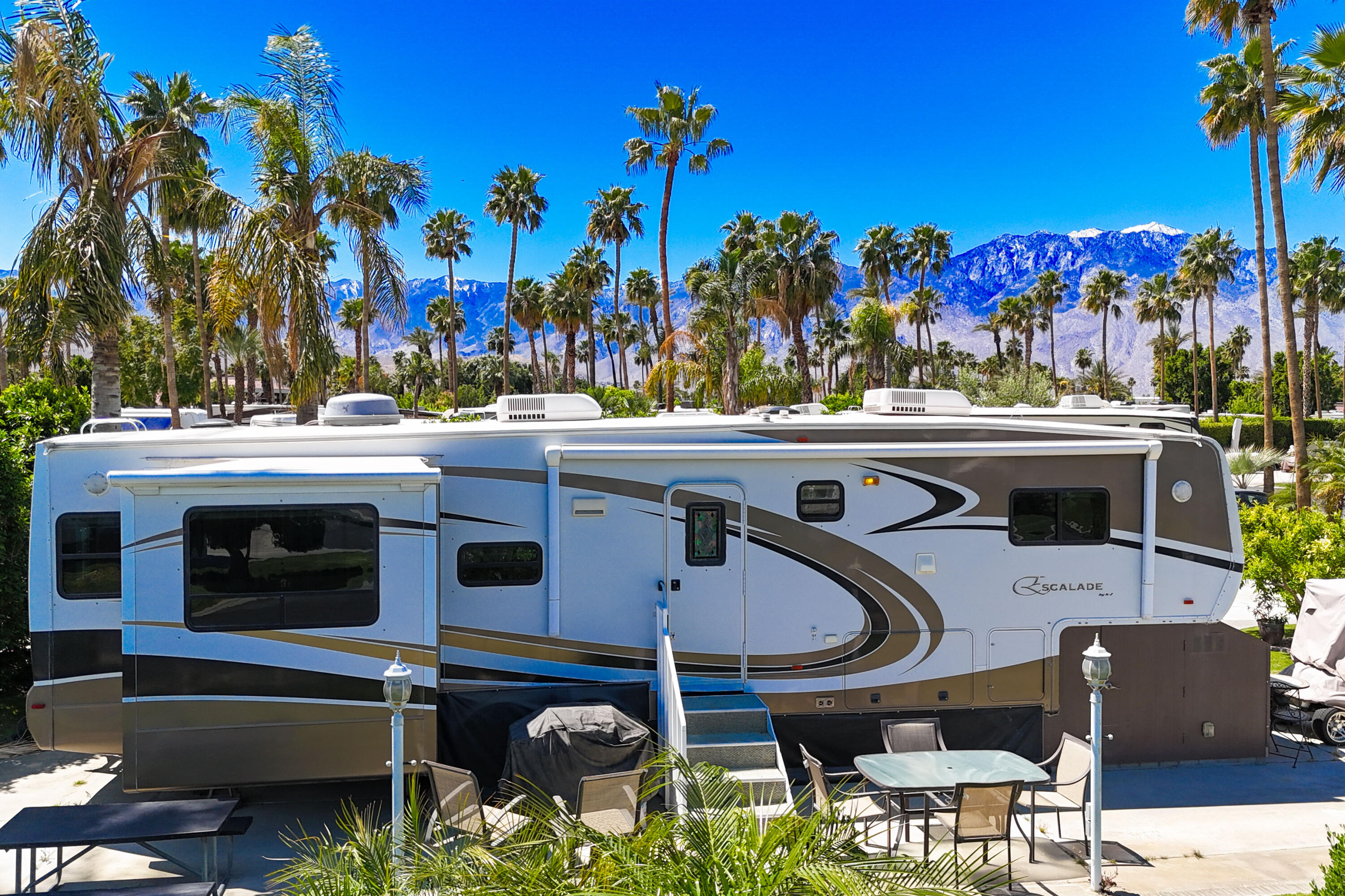 69411 Ramon Road, Unit 504 Cathedral City, CA 92234 - Photo 17 of 56 a view of a patio with table and chairs potted plants