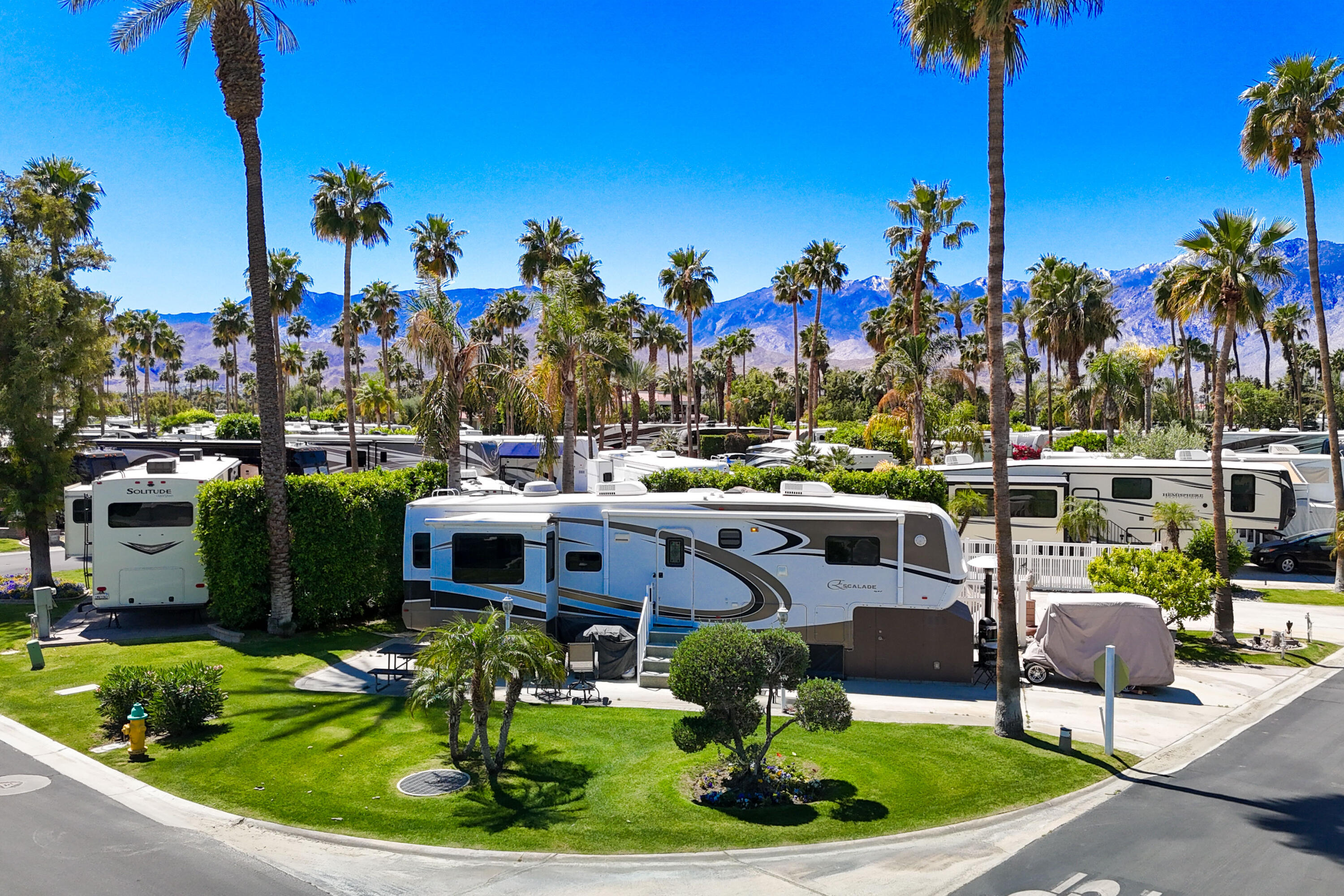 69411 Ramon Road, Unit 504 Cathedral City, CA 92234 - Photo 5 of 56 a front view of a house with a garden and trees
