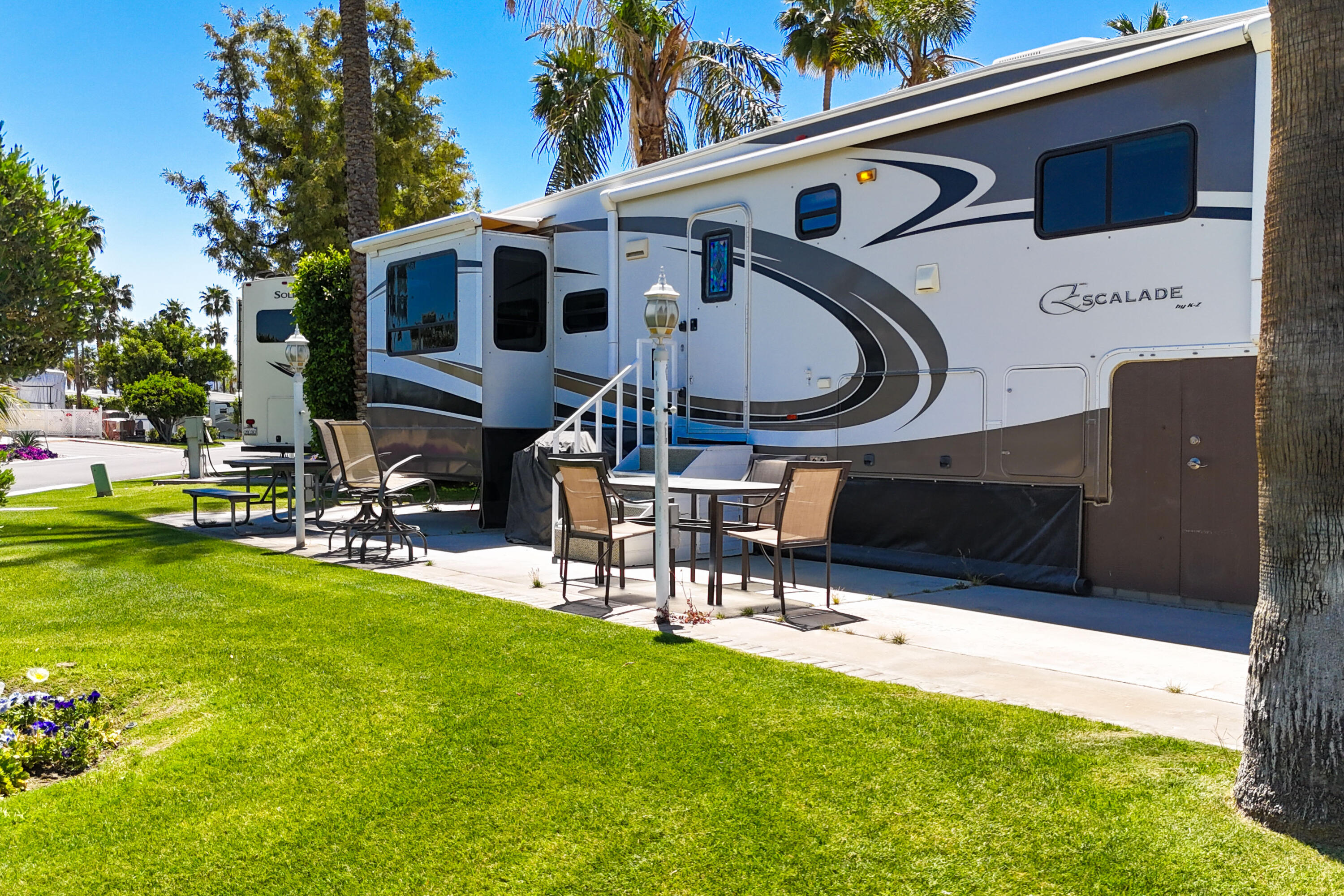 69411 Ramon Road, Unit 504 Cathedral City, CA 92234 - Photo 10 of 56 a view of a patio with a table and chairs