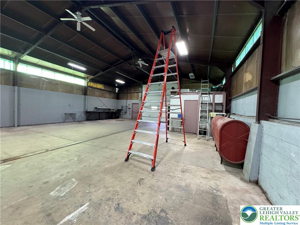 868 Catawissa Road Tamaqua, PA 18252 - Photo 55 of 67 A spacious, high-ceilinged workshop offering ample room for various projects and equipment storage.