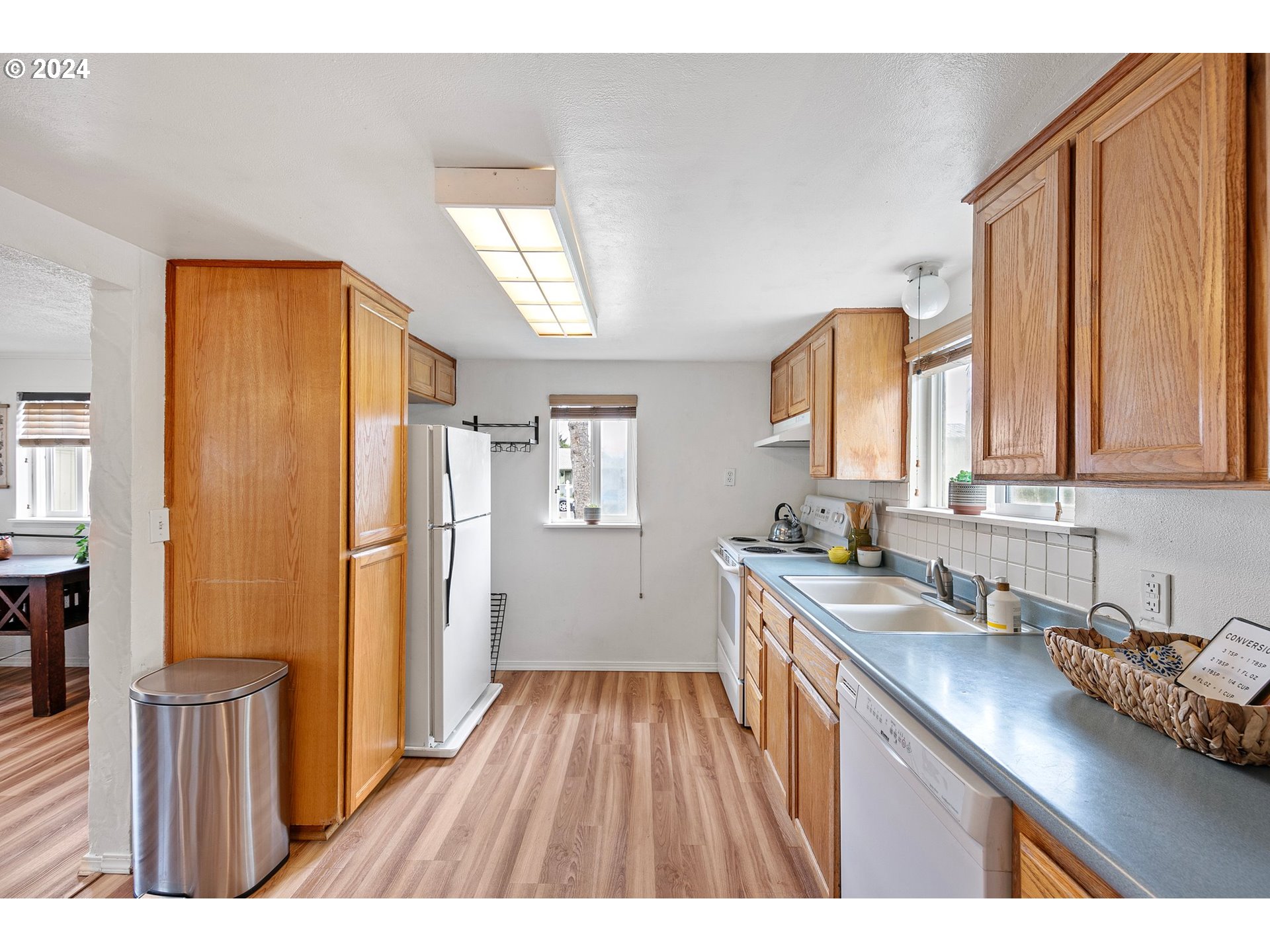 280 South 35th Street Springfield, OR 97478 - Photo 5 of 12 a open kitchen with a sink a refrigerator and wooden floor