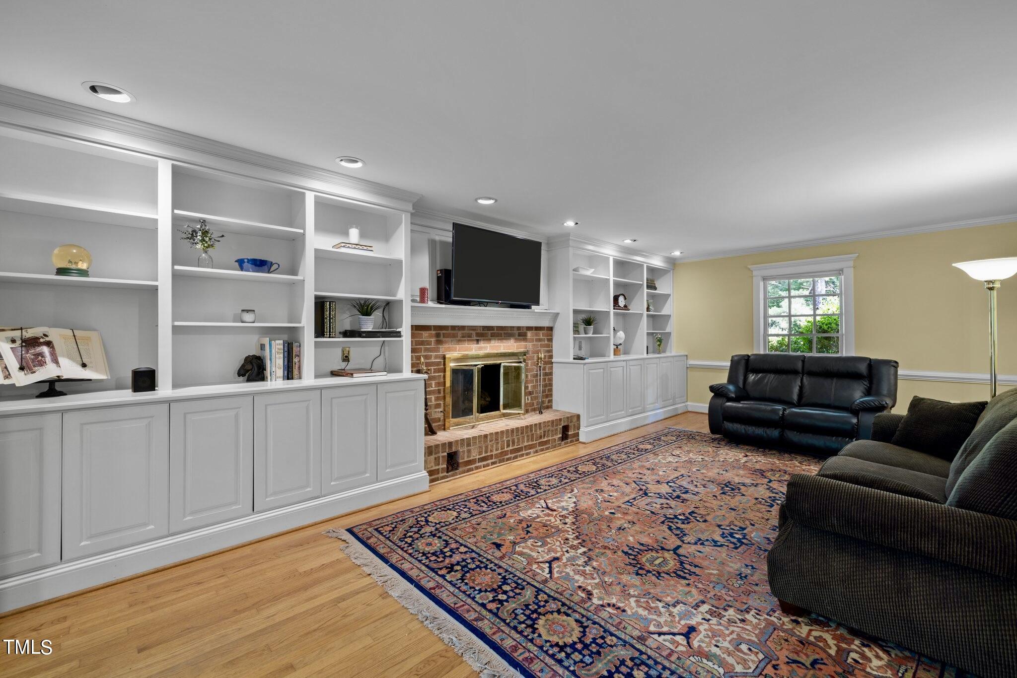 4099 Blackard Pond Road Raleigh, NC 27604 - Photo 26 of 94 a living room with furniture a flat screen tv and a fireplace