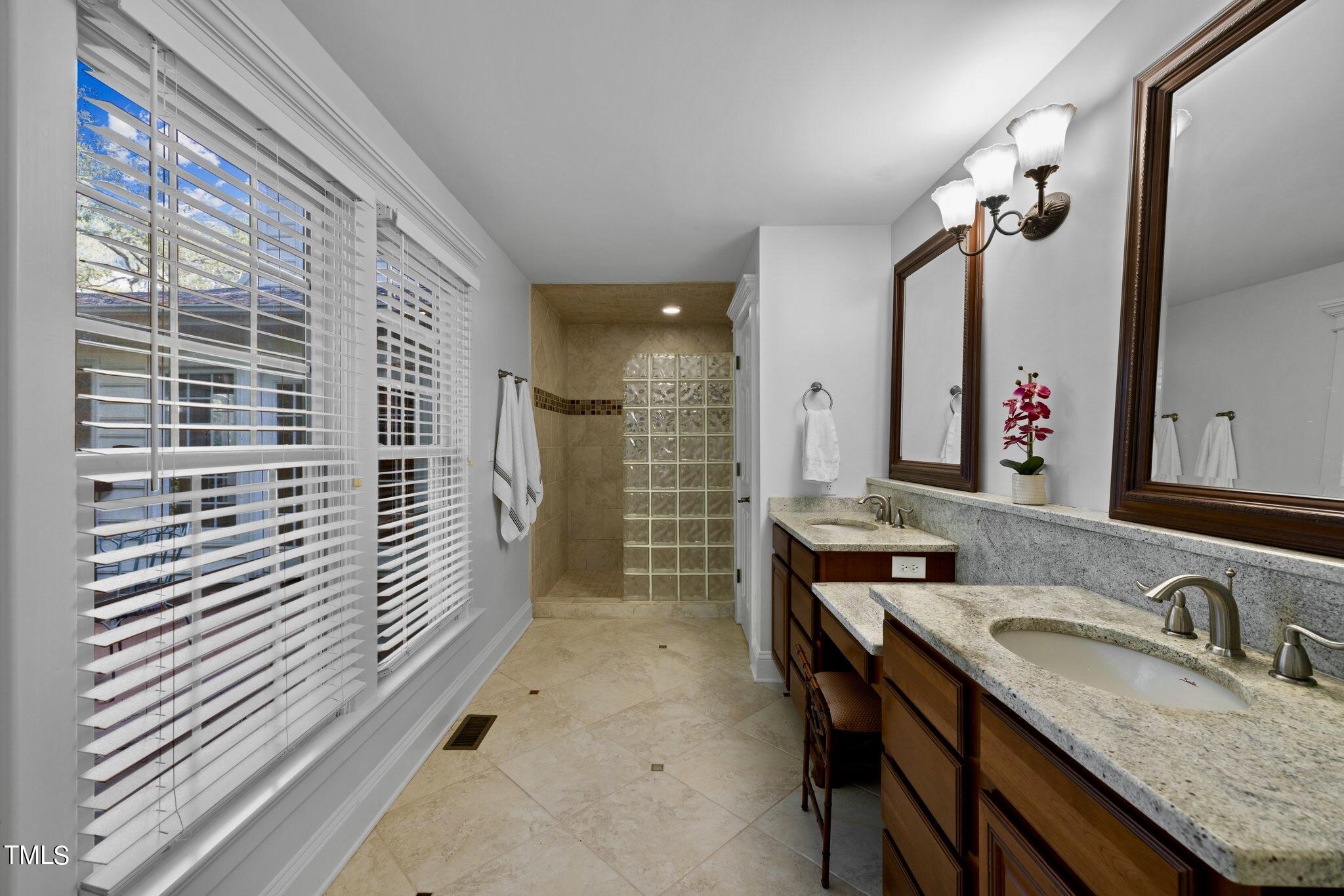 4099 Blackard Pond Road Raleigh, NC 27604 - Photo 45 of 94 a bathroom with a granite countertop sink and a mirror