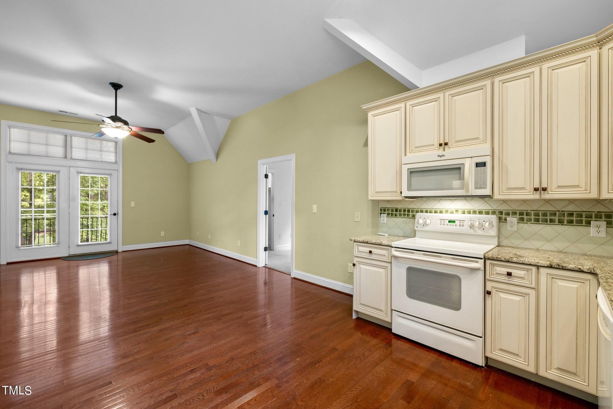 4099 Blackard Pond Road Raleigh, NC 27604 - Photo 57 of 94 a kitchen with wooden floors and white appliances