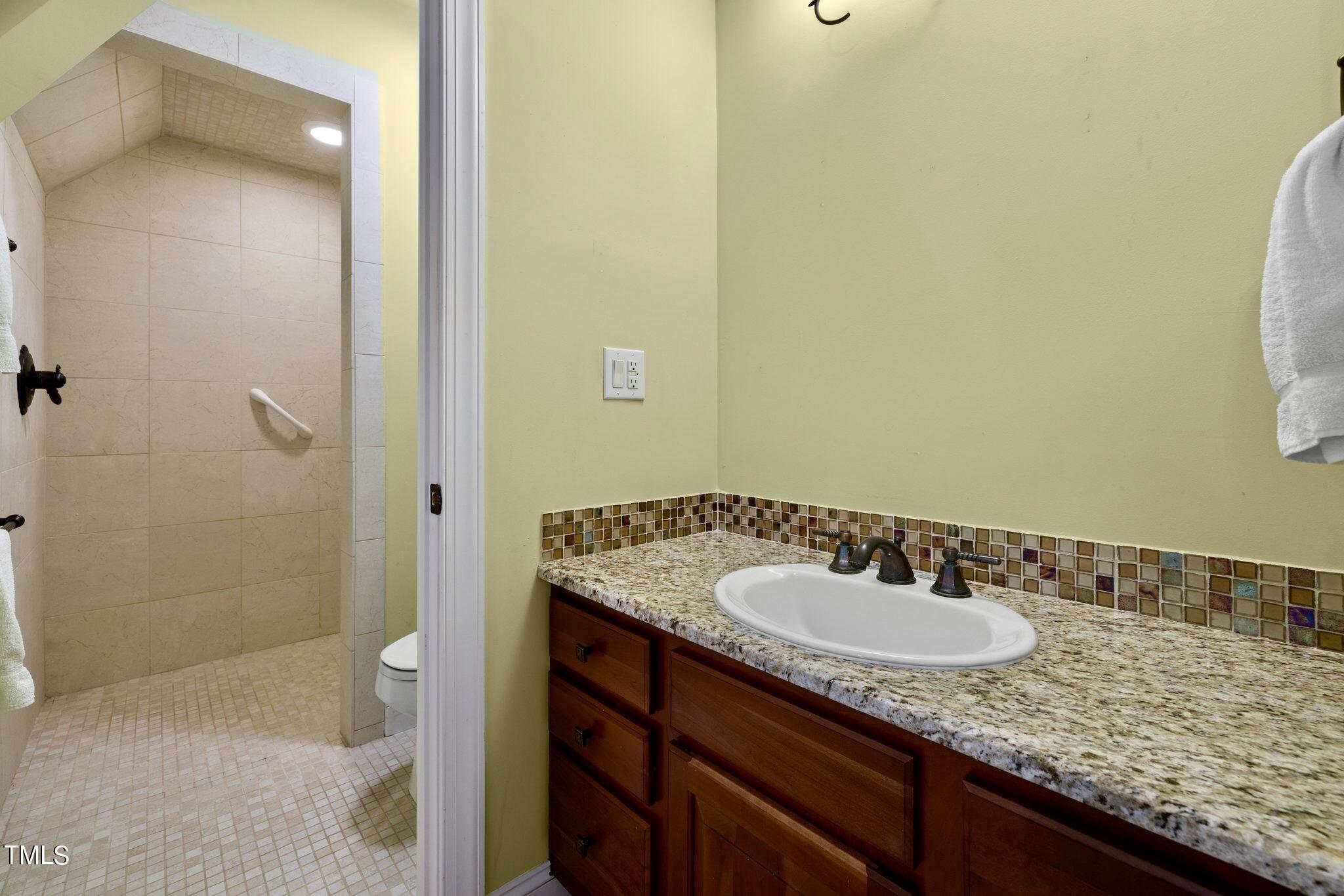 4099 Blackard Pond Road Raleigh, NC 27604 - Photo 60 of 94 a bathroom with a granite countertop sink and a mirror