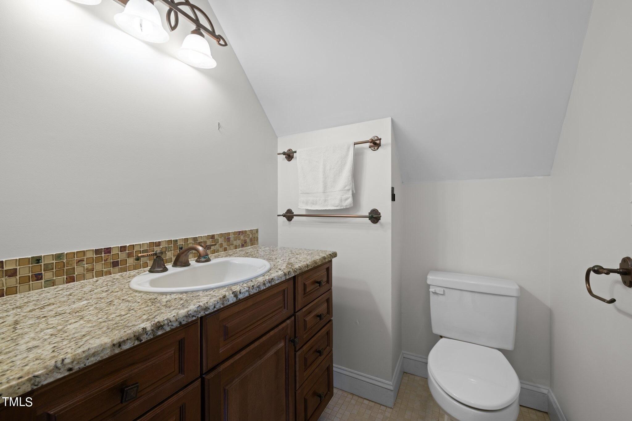 4099 Blackard Pond Road Raleigh, NC 27604 - Photo 63 of 94 a bathroom with a granite countertop toilet sink and mirror