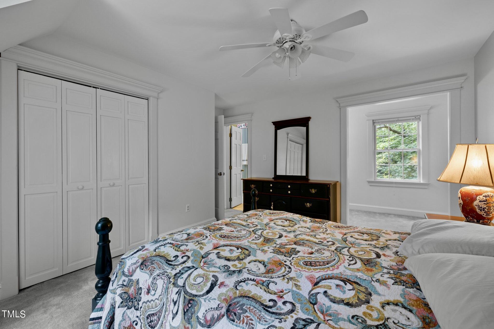 4099 Blackard Pond Road Raleigh, NC 27604 - Photo 70 of 94 a bedroom with a large bed and a chandelier