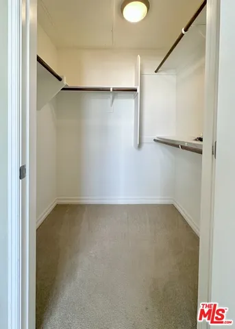 a spacious bathroom with a toilet a sink and a mirror