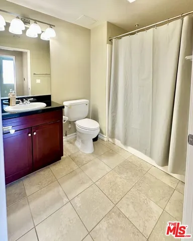 a bathroom with a shower and a toilet