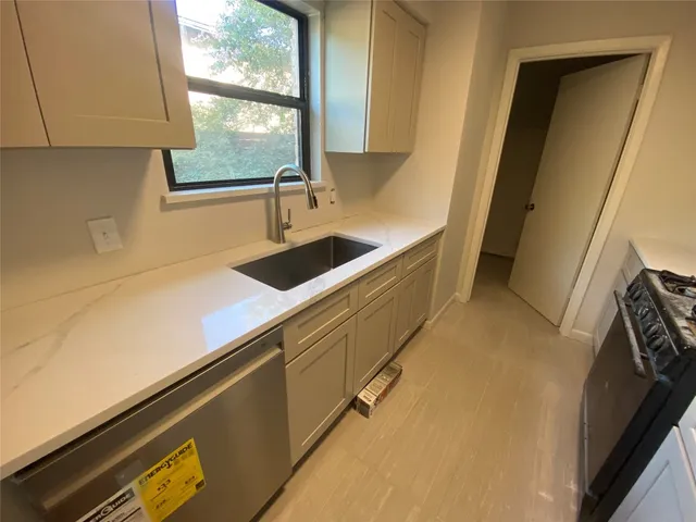 a kitchen with a sink and a window