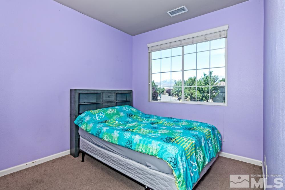 1893 Resistol Drive Reno, NV 89521 - Photo 18 of 26 a bed sitting in a bedroom next to a window