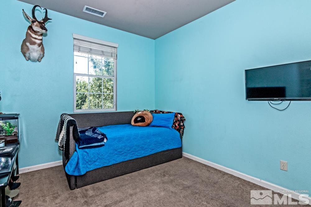 1893 Resistol Drive Reno, NV 89521 - Photo 20 of 26 a bedroom with a bed and a window