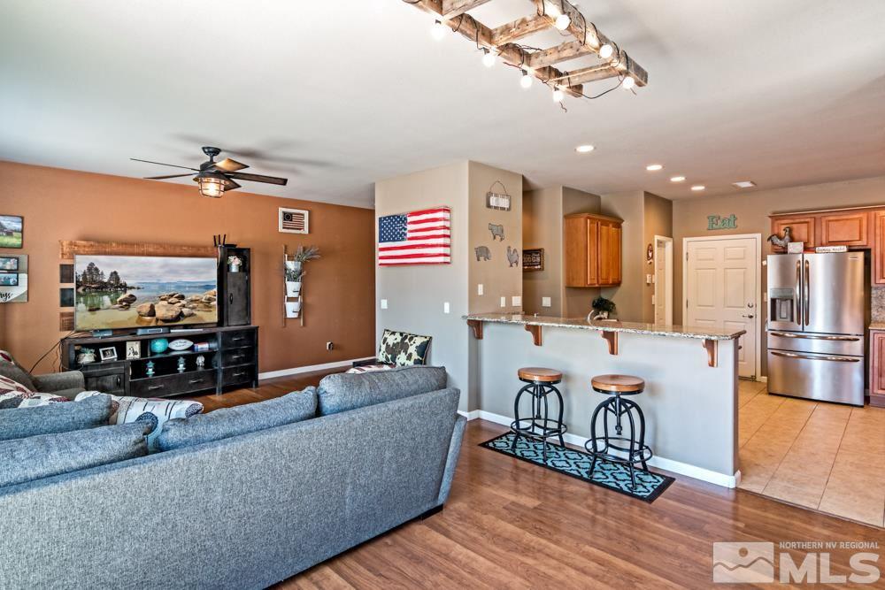 1893 Resistol Drive Reno, NV 89521 - Photo 8 of 26 a living room with fireplace furniture and a flat screen tv