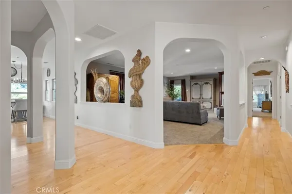 a kitchen with stainless steel appliances granite countertop a stove a sink dishwasher and a dining table with chairs