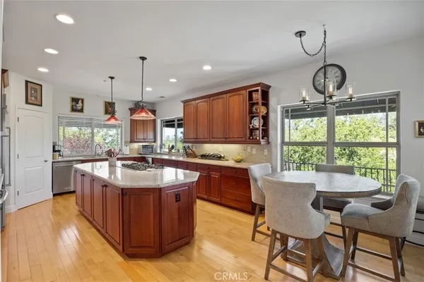 a kitchen with granite countertop wooden cabinets a sink and a window
