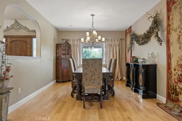 a view of a dining room with furniture and chandelier
