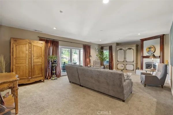 a living room with a fireplace and a wooden floor