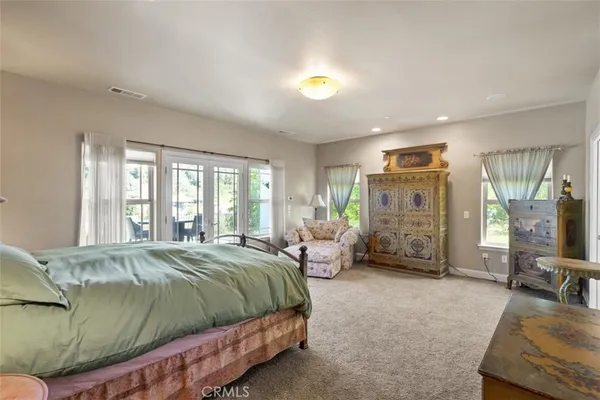 a bedroom with a bed and a lamp with window