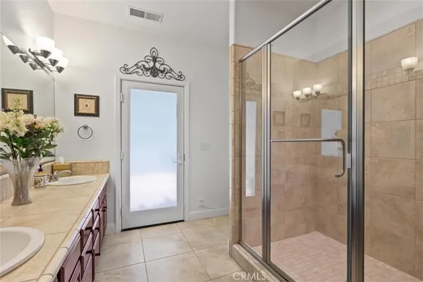 a bathroom with a double vanity sink and a mirror
