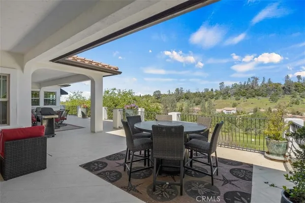 a view of a chairs and table in patio