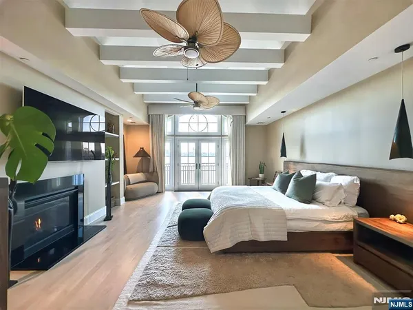 a spacious bedroom with a bed and a chandelier