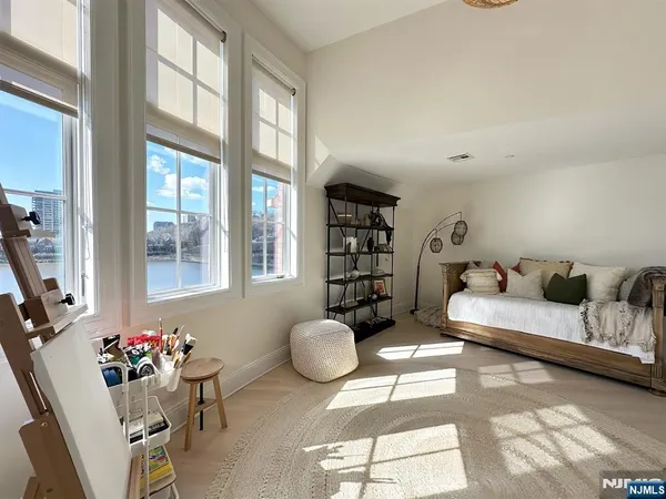 a spacious bedroom with a bed and a chandelier
