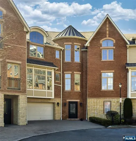 a front view of a residential apartment building with a yard