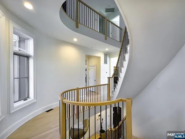 a spacious bedroom with a bed and a television