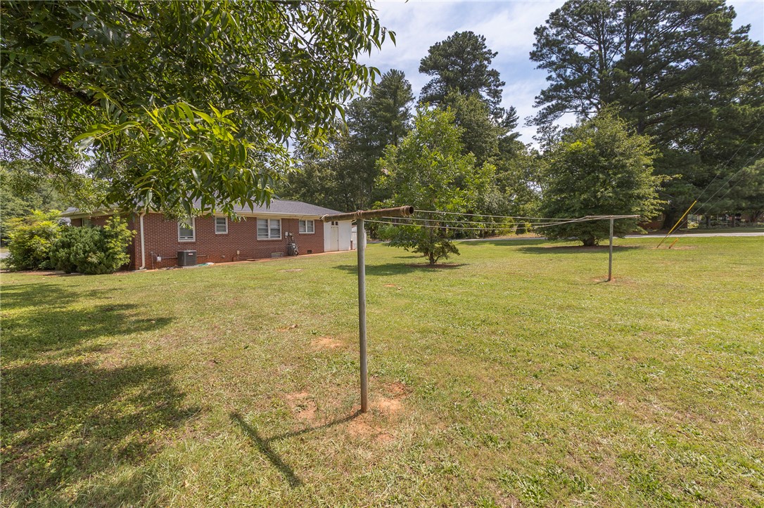 1218 Bolt Drive Anderson, SC 29621 - Photo 42 of 46 A spacious yard surrounds this traditional brick home, offering ample outdoor enjoyment.
