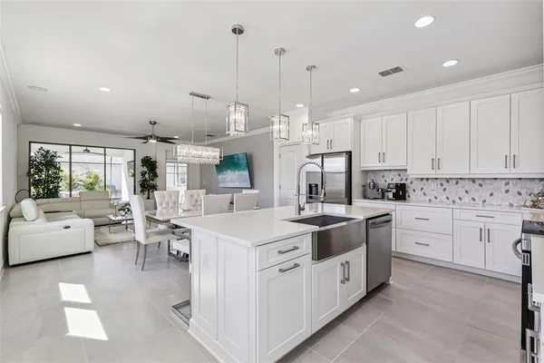 a kitchen with white cabinets and white appliances