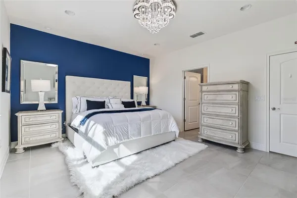 a bedroom with a bed and a dresser