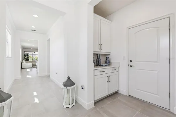 a kitchen with white cabinets and white appliances