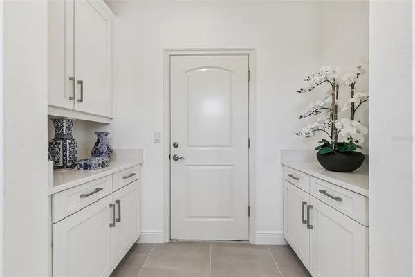 a kitchen with white cabinets and white appliances