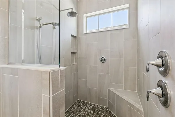 a bathroom with a shower and a sink