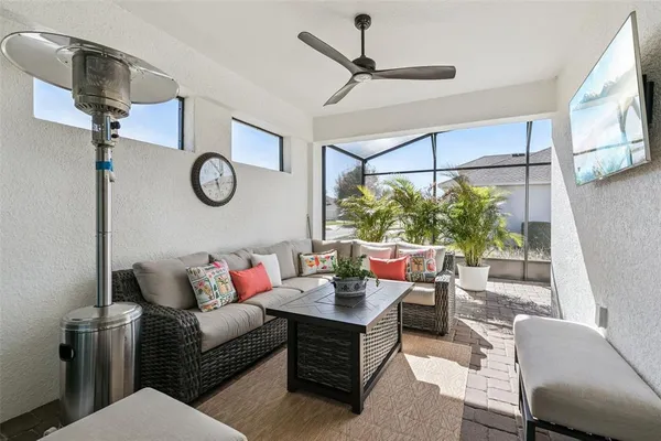 a living room with furniture a clock and a window