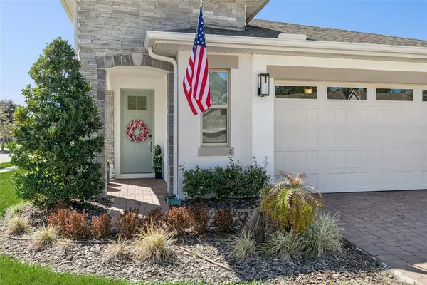a front view of a house with plants