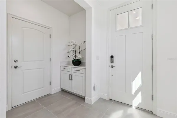 a view of a bathroom with white cabinets