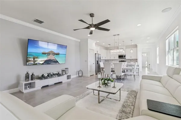 a living room with furniture a rug and a flat screen tv