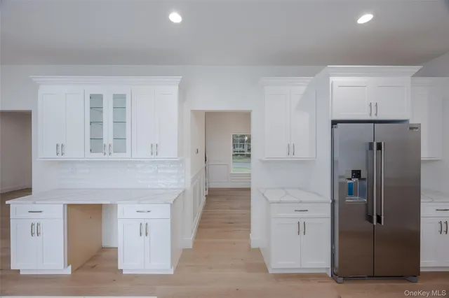 wooden floor with white cabinets