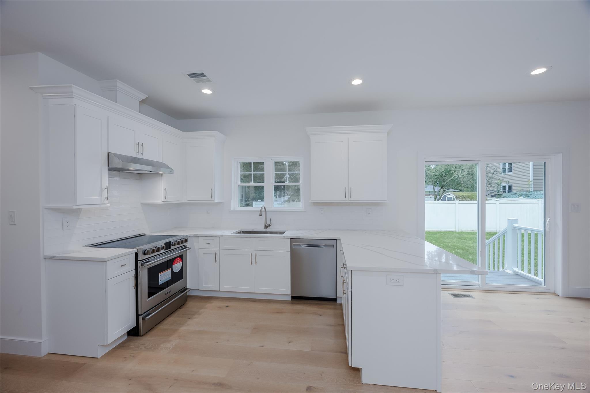 40 Zenith Road Rocky Point, NY 11778 - Photo 12 of 38 a kitchen with stainless steel appliances granite countertop a stove a sink and a refrigerator