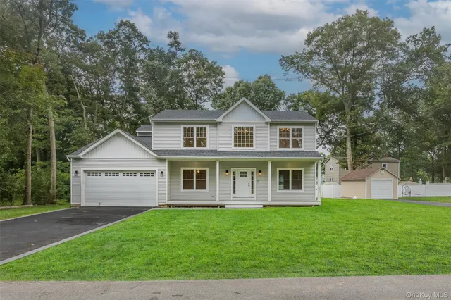 a front view of a house with a garden and yard
