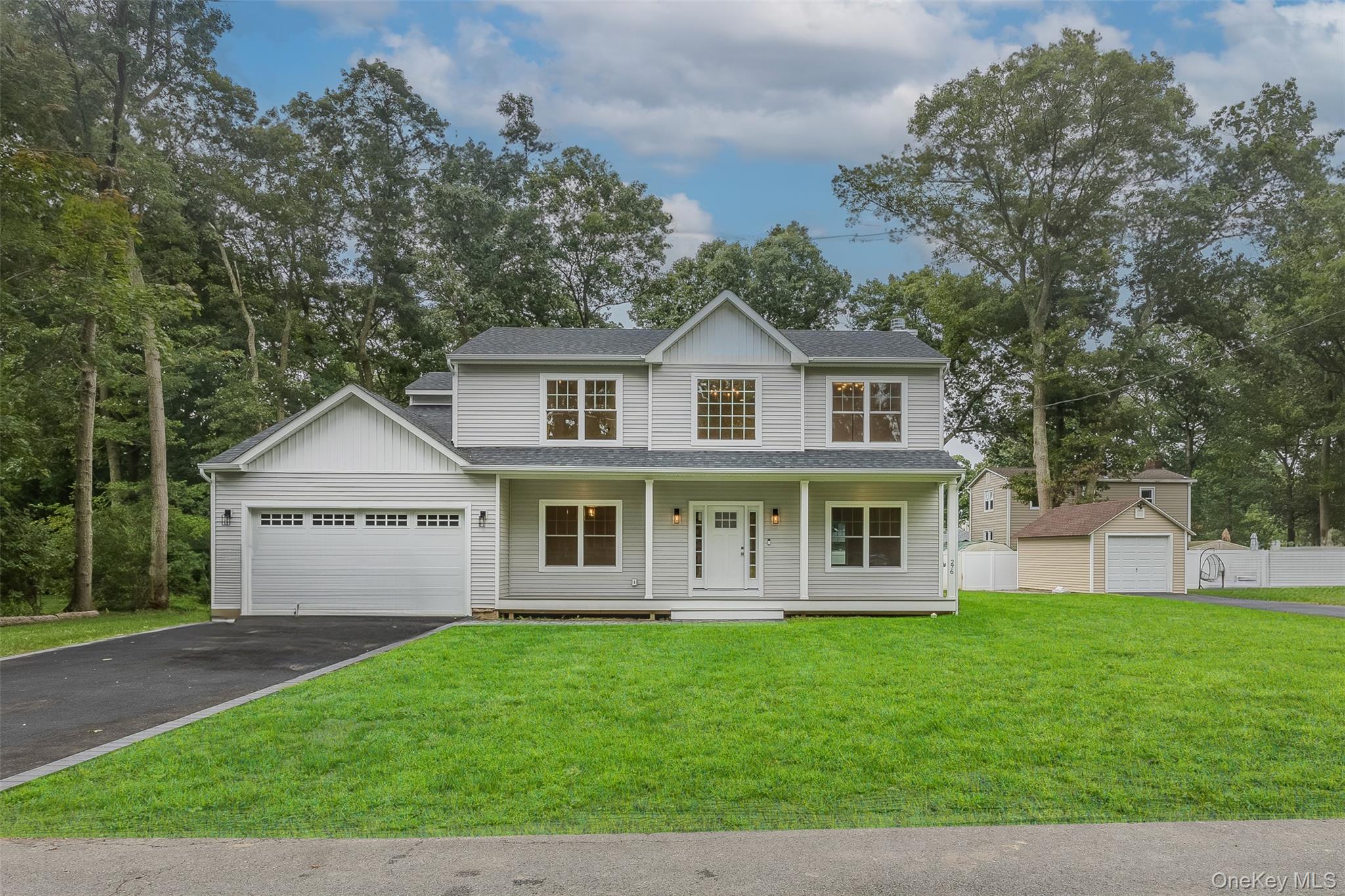 40 Zenith Road Rocky Point, NY 11778 - Photo 2 of 38 a front view of a house with a garden and yard