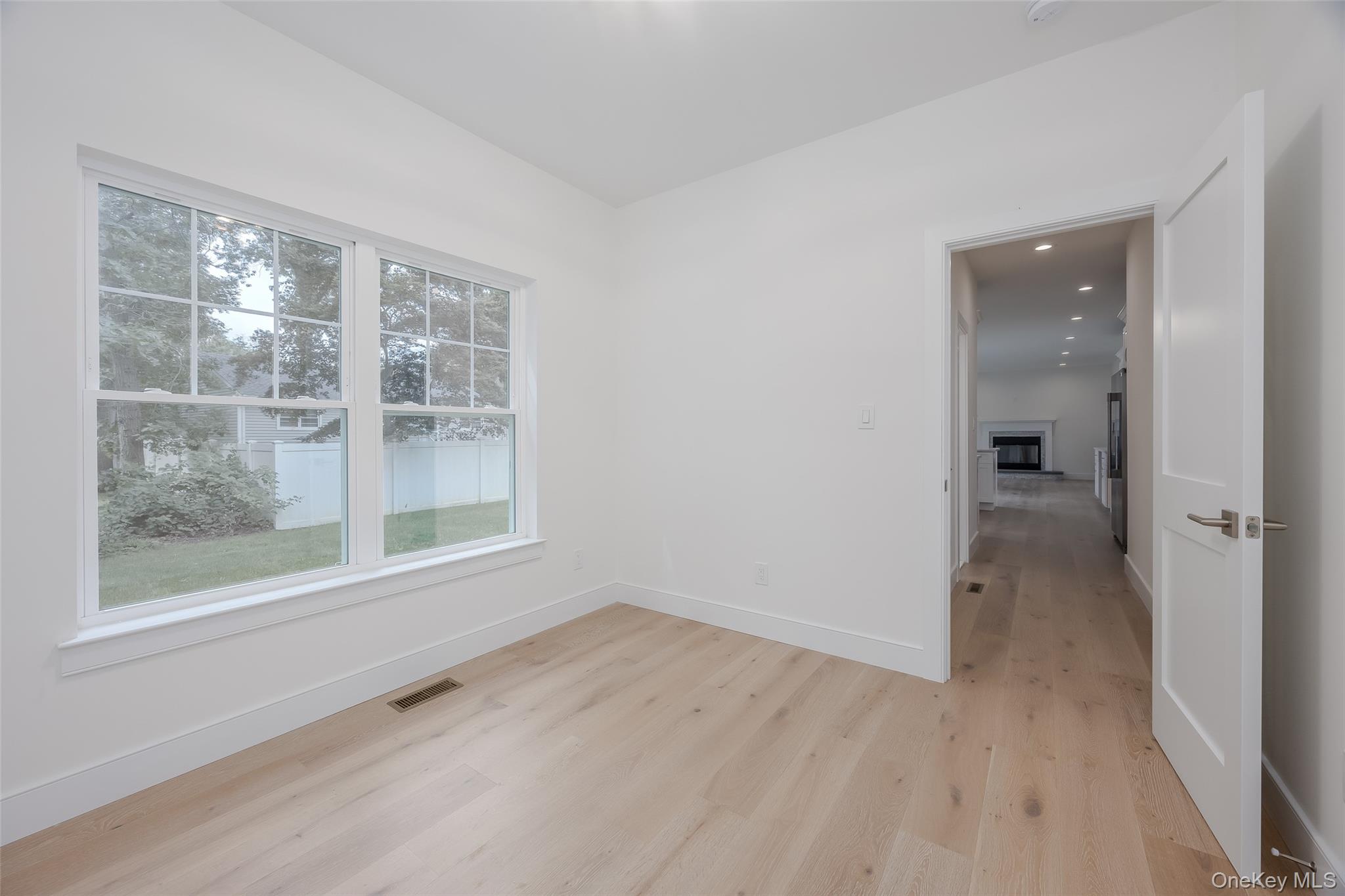 40 Zenith Road Rocky Point, NY 11778 - Photo 22 of 38 wooden floor in an empty room with a window