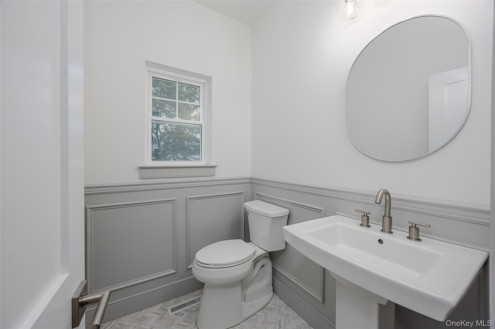 40 Zenith Road Rocky Point, NY 11778 - Photo 23 of 38 a bathroom with a toilet a sink and mirror